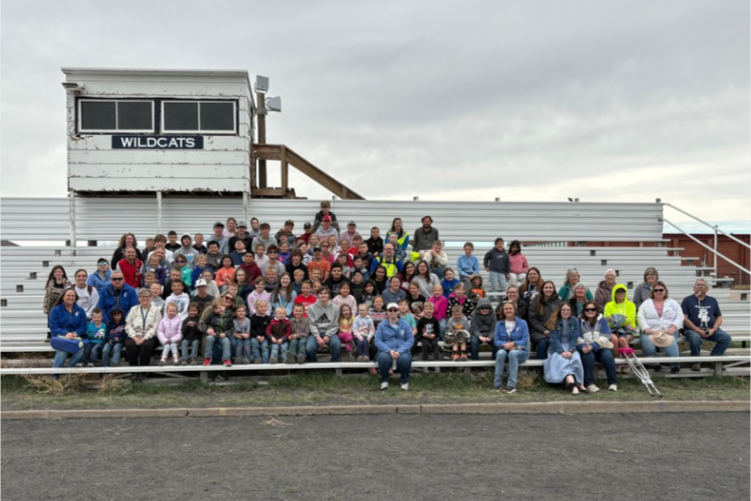 Group of students sitting on the bleachers 