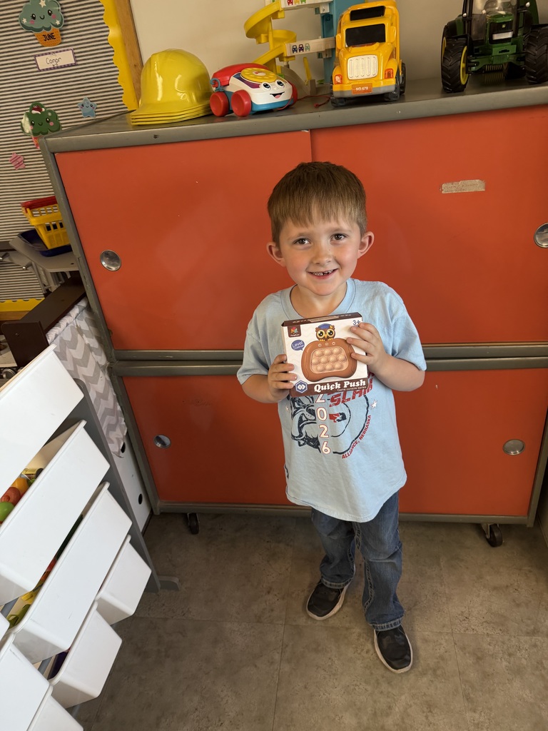 Student holding a prize for reading
