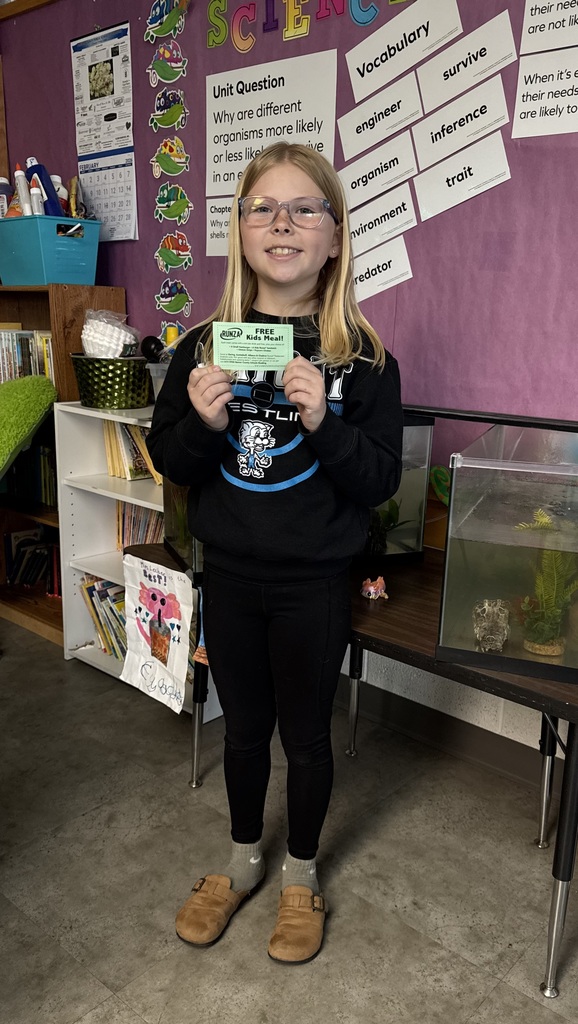 Student holding a prize for reading