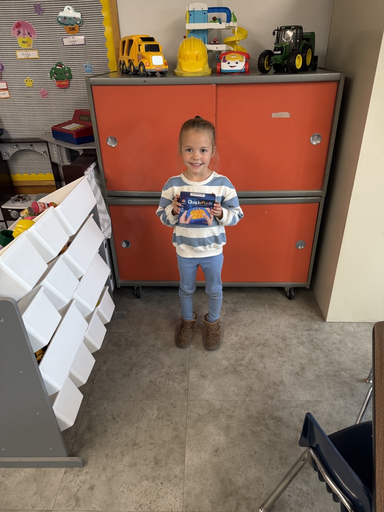 Student holding a prize for reading