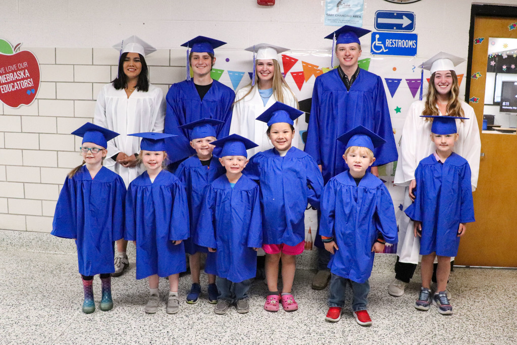 Seniors and PreK standing with their caps and gowns 