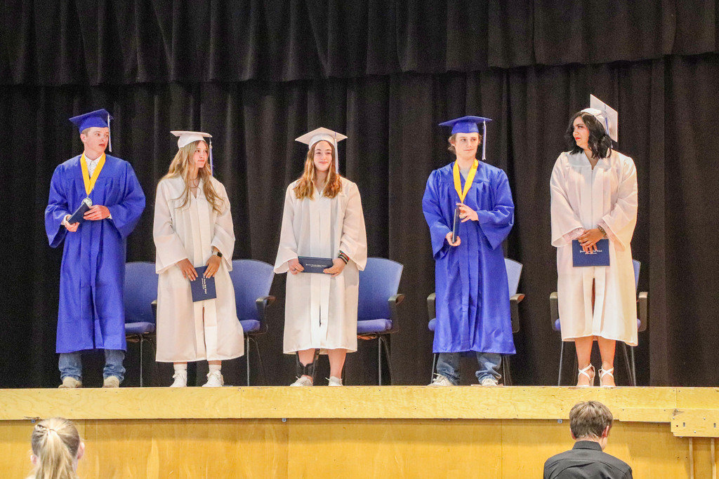 Students on stage after receiving their diploma 