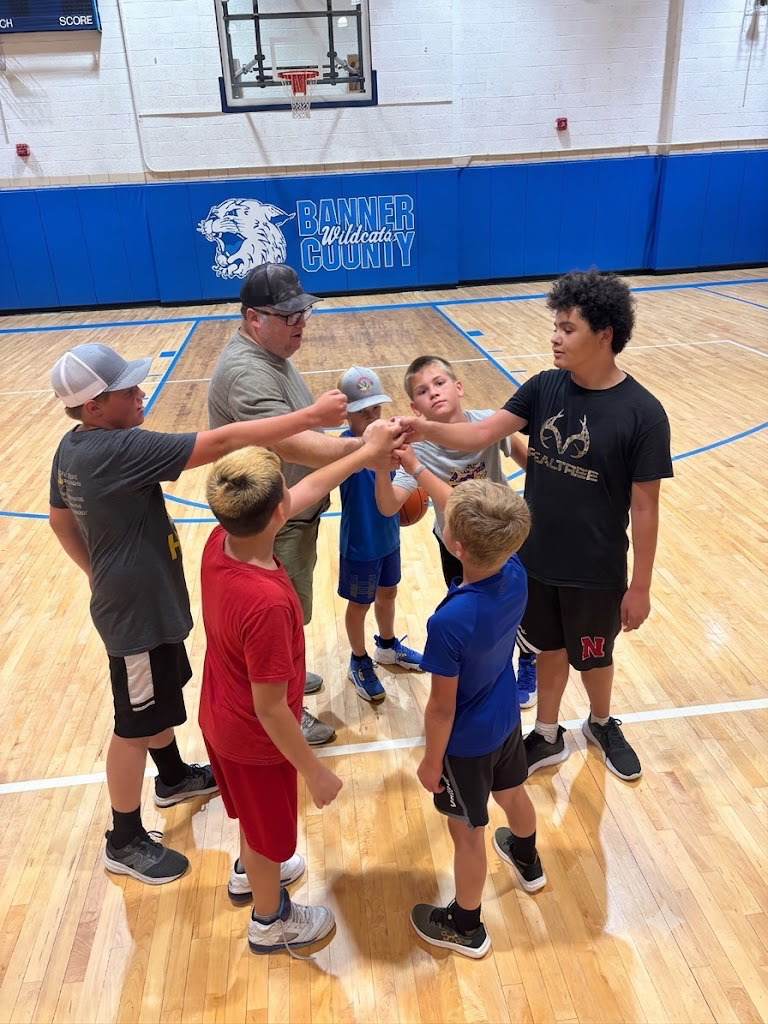 boys in a team huddle after playing basketball 