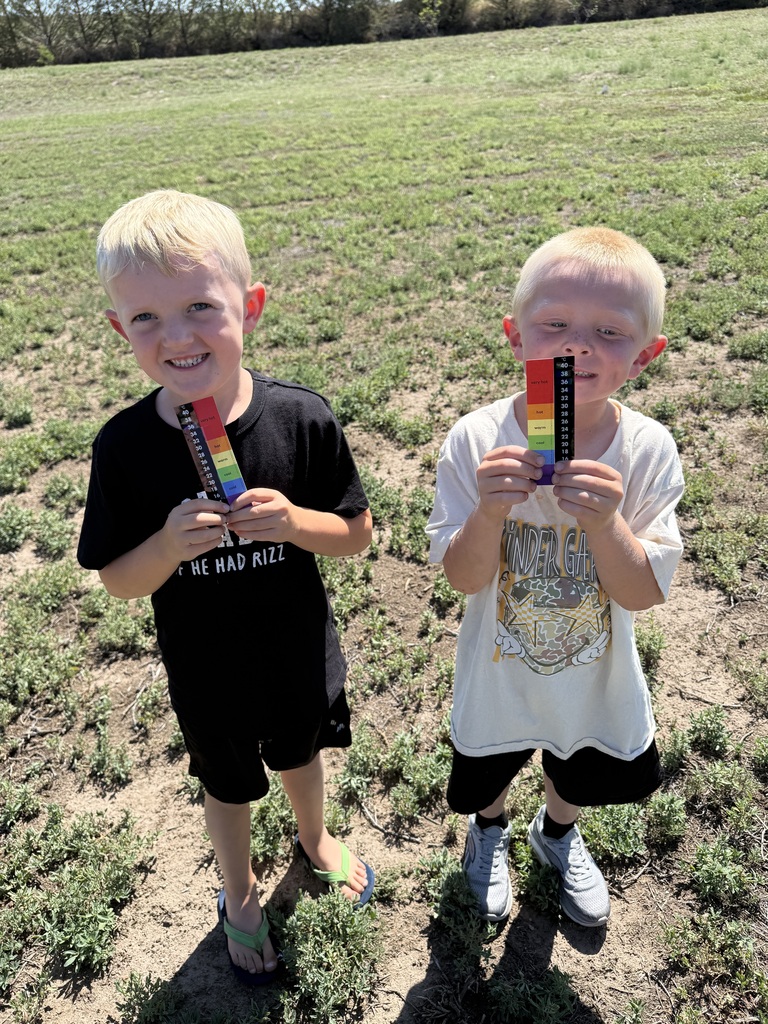 2 boys holding a thermometer