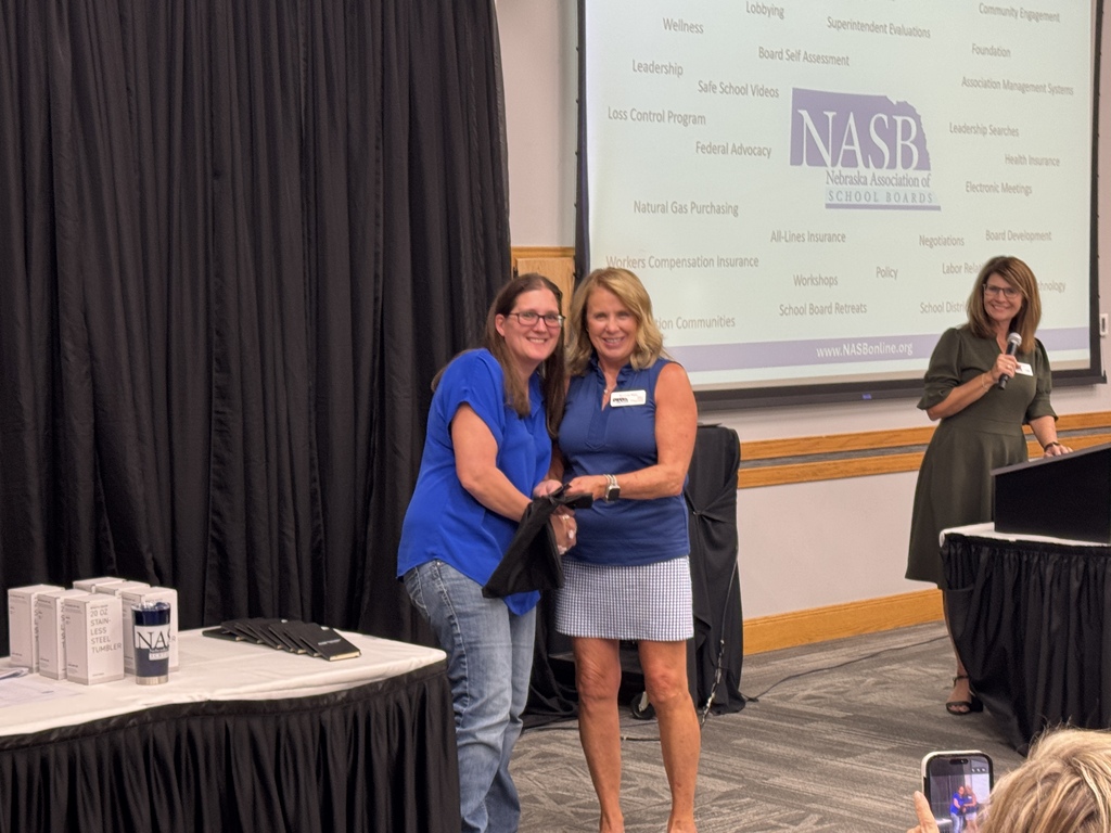 Two people holding an award