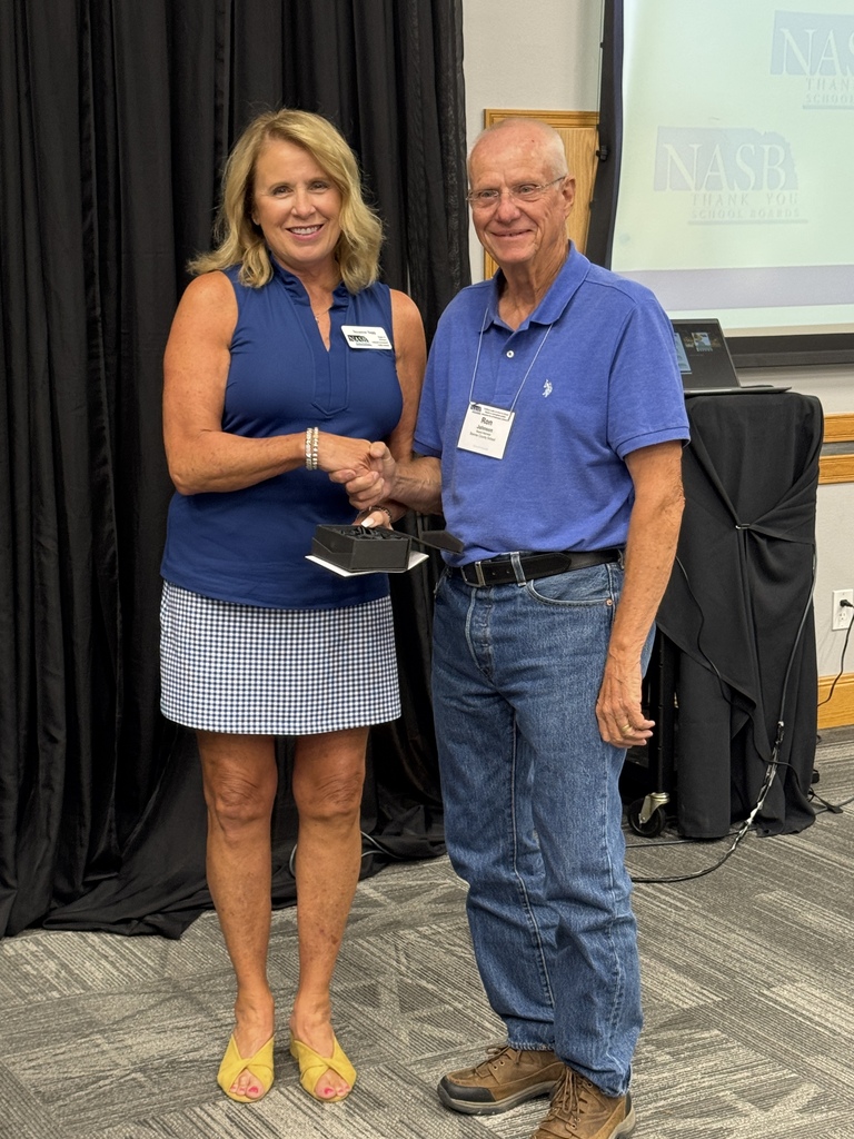 Two people holding an award