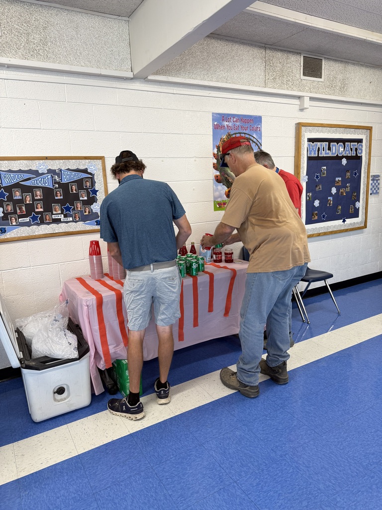 Two men standing by a table pouring a Shirly temple drink