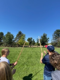 Students holding a pole
