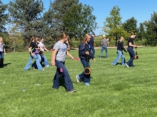 Students looking for something in the grass