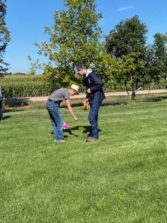Students looking for something in the grass