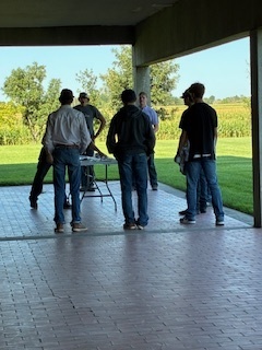 Students standing around a table