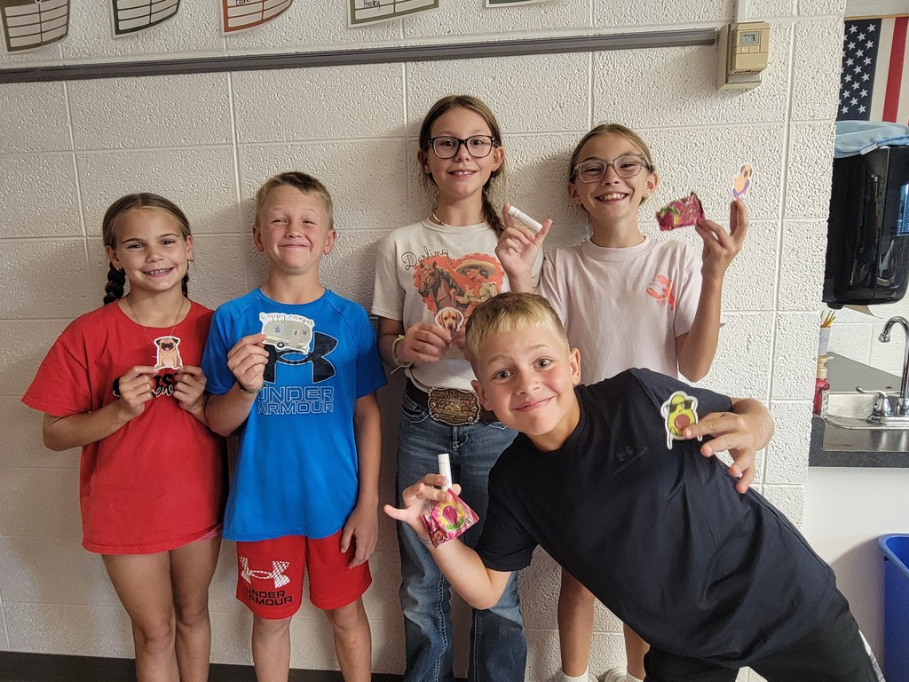 A group of students holding prizes for reading