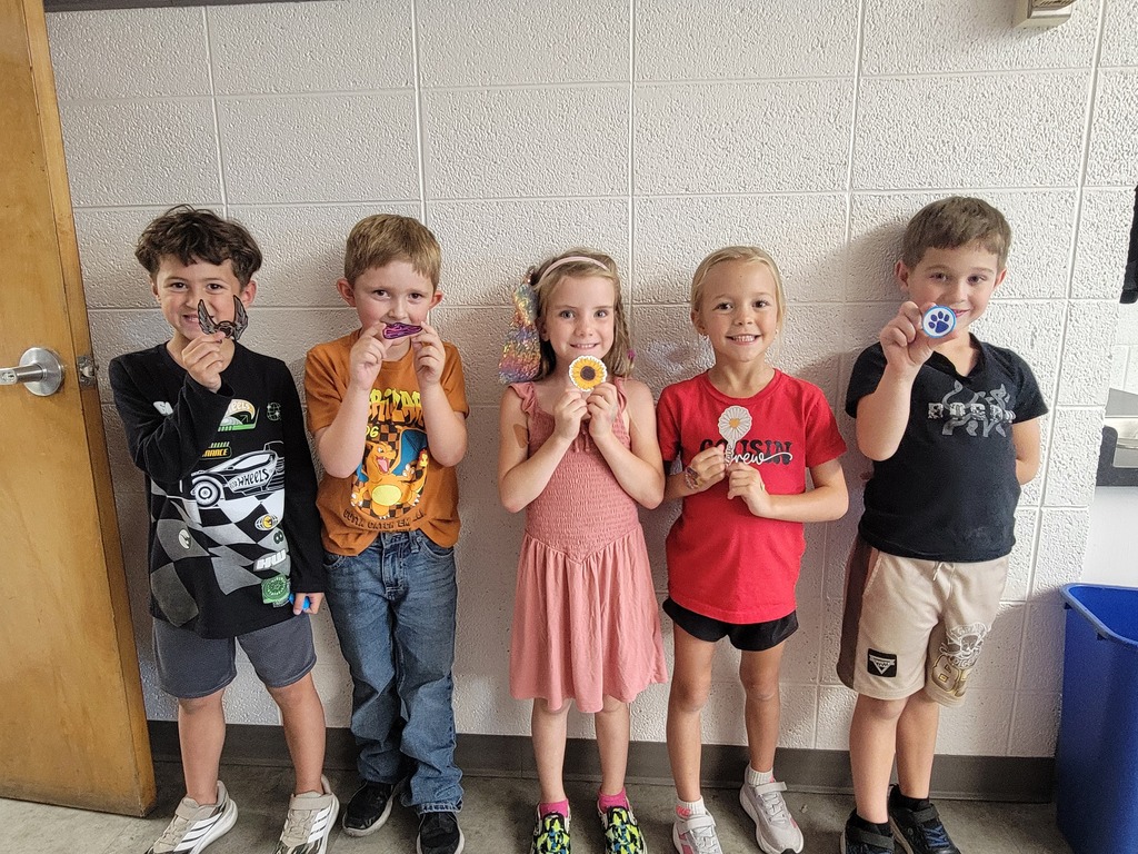 A group of students holding prizes for reading