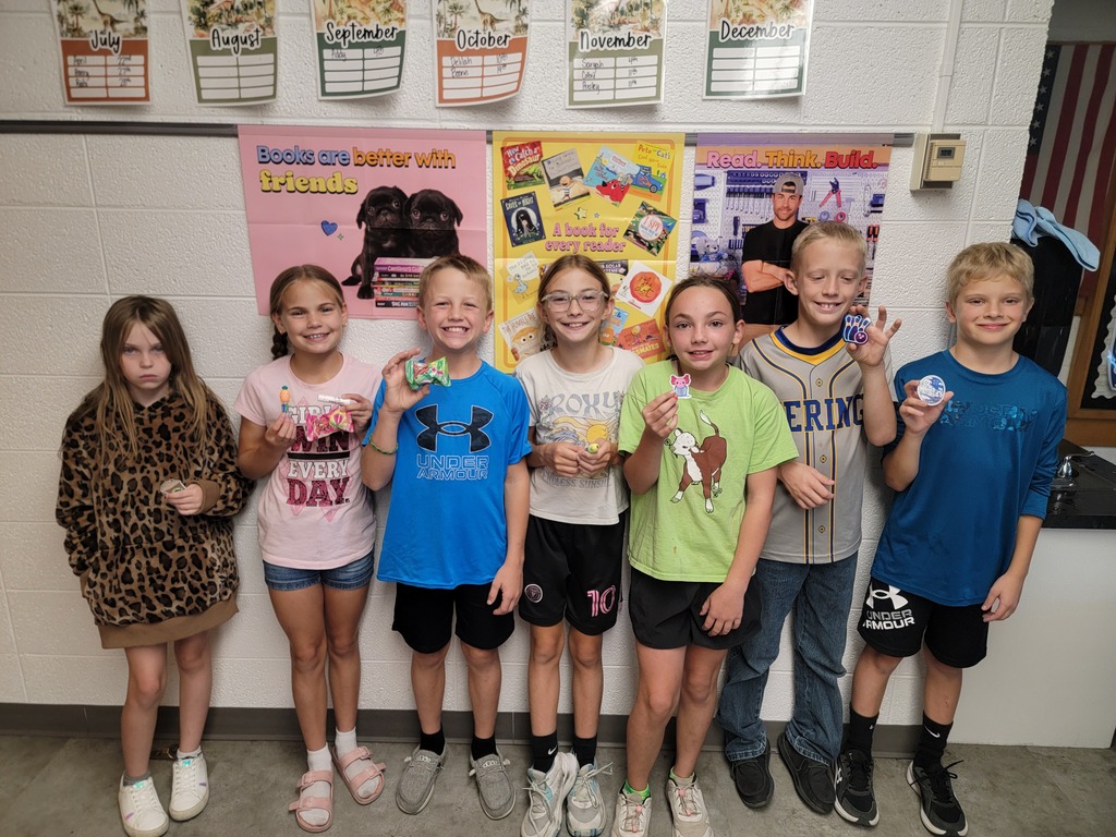 Students holding prizes for reading