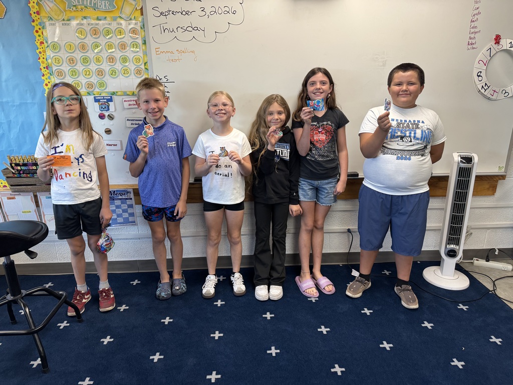 Students holding prizes for Reading. 