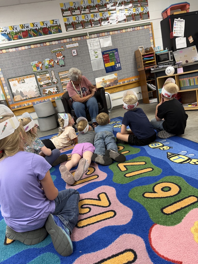 Woman reading to students