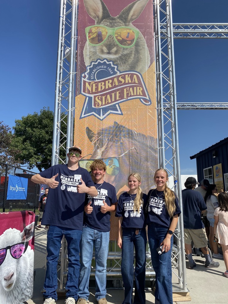 Students in front of the state fair sign