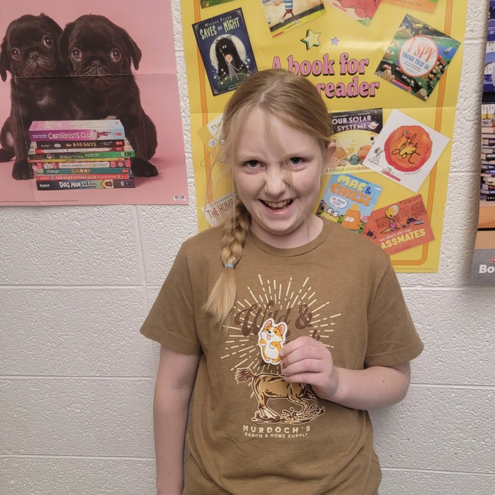 Student holding a sticker