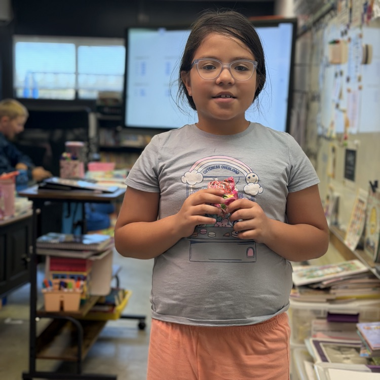 student holding a sticker 