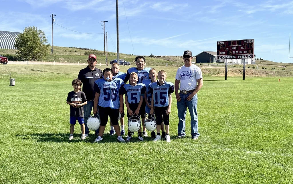 Football Team standing by the scoreboard