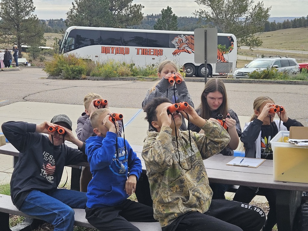 Students looking through binoculars 