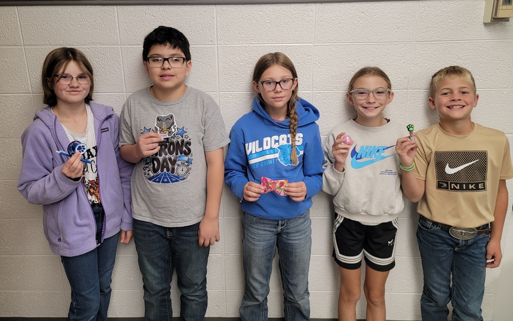 Student holding a prize for reading.