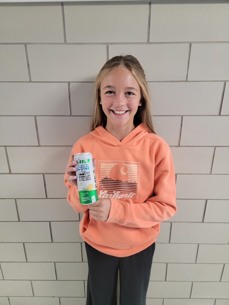 Student holding a prize for reading.