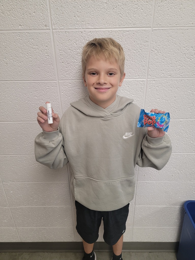 Student holding a prize for reading.