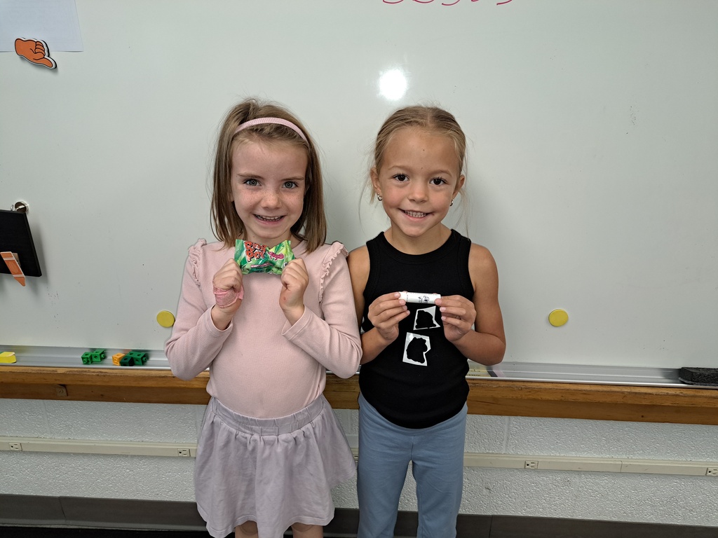 Student holding a prize for reading.