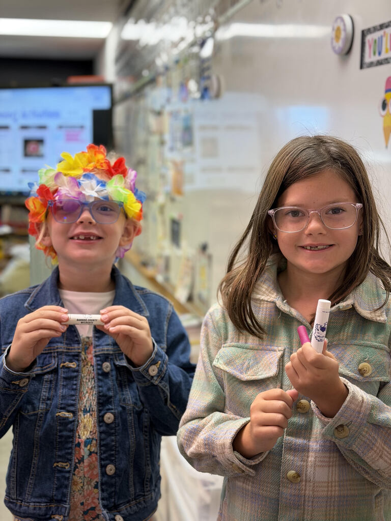 Students holding prizes for reading