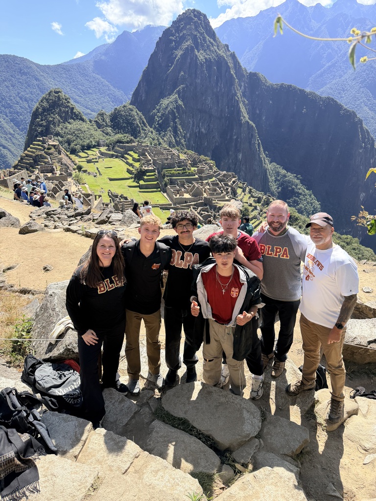 group of BLPA students and chaperones with mountainous background