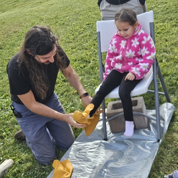 girl putting on moccasins