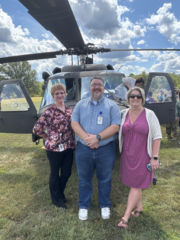 principals with black Hawk helicopter