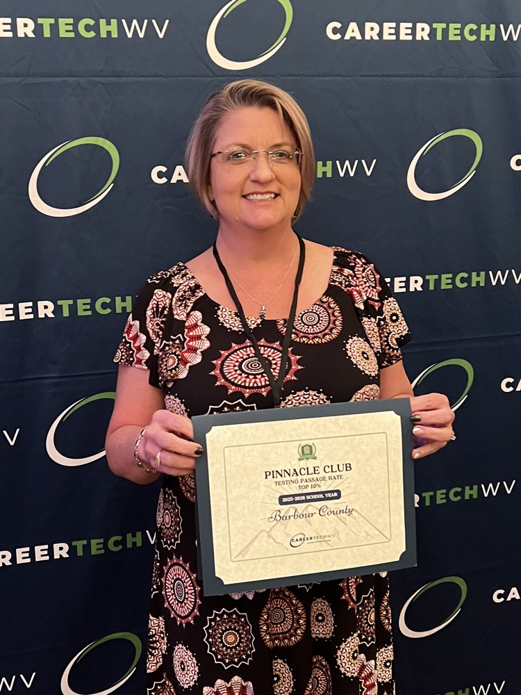 photo of CTE Director Mrs. Ferguson holding certificate