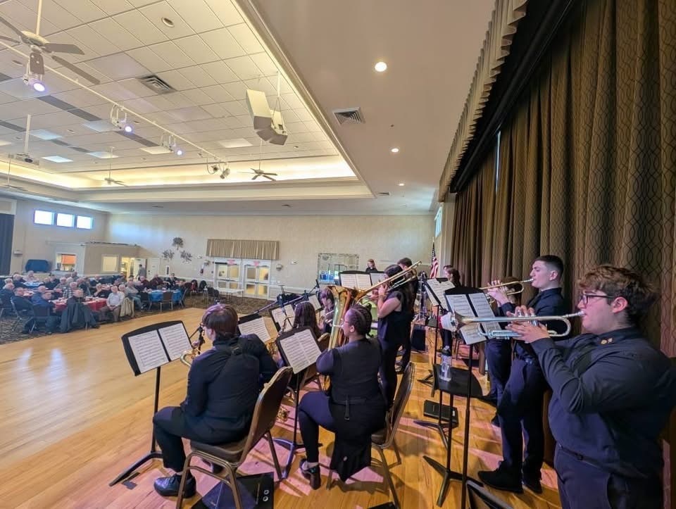 Image of the BHS Jazz Band performing for the Mirage Men's Club in their clubhouse.