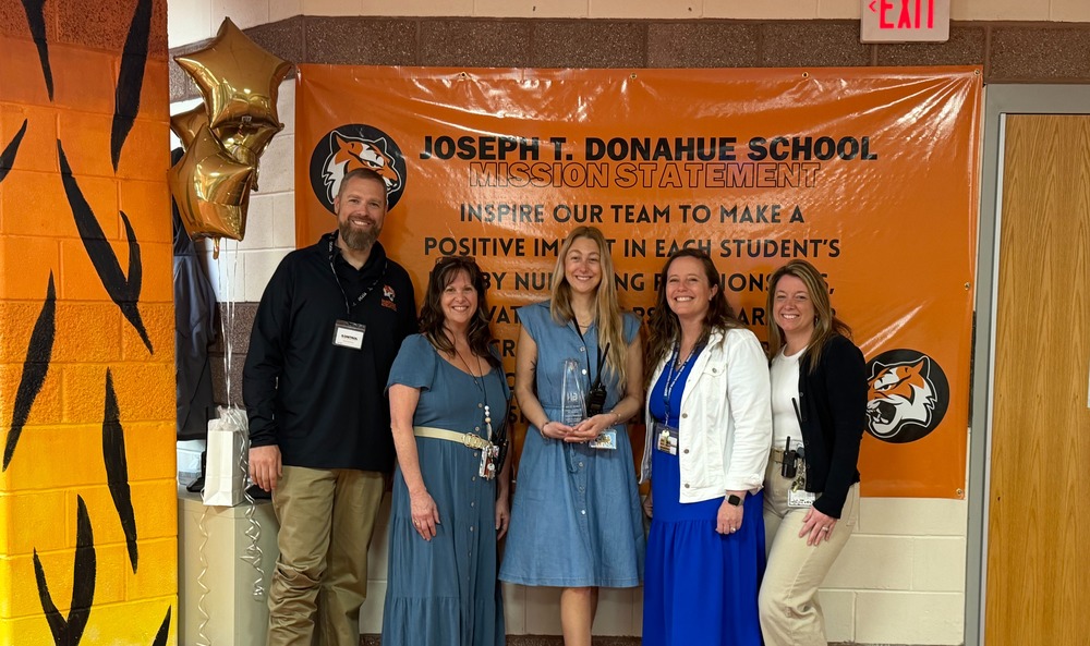 Image of Jennifer holding her award and posing with the Superintendent, Principal, Supervisor of Guidance, and the Vice Principal. 