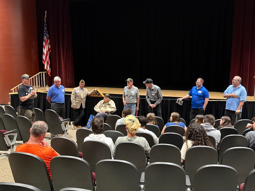 Members of the VFW addressing students in the auditorium