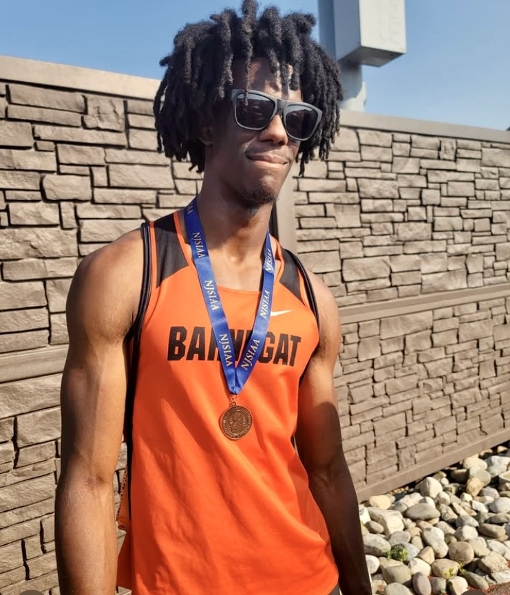 Picture of Kyle proudly wearing his medal.