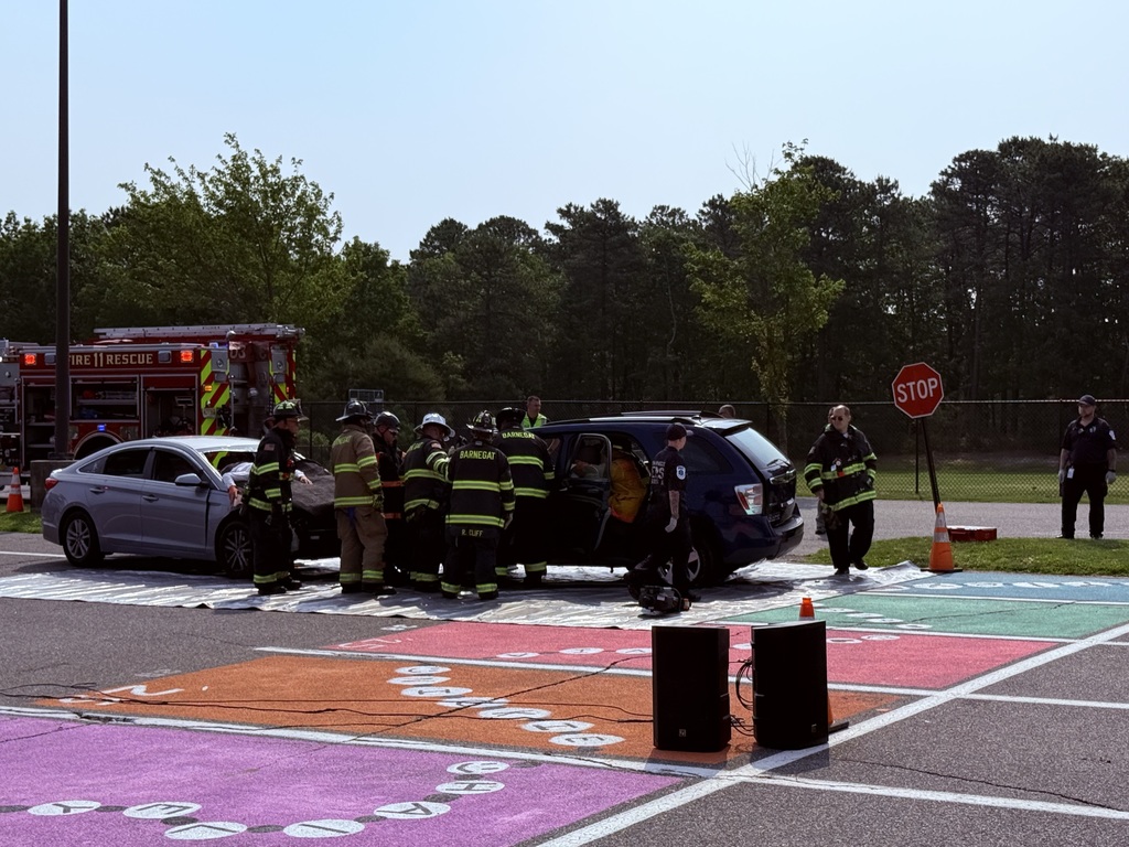 Picture of members of the fire department extricating student from one of the cars. 