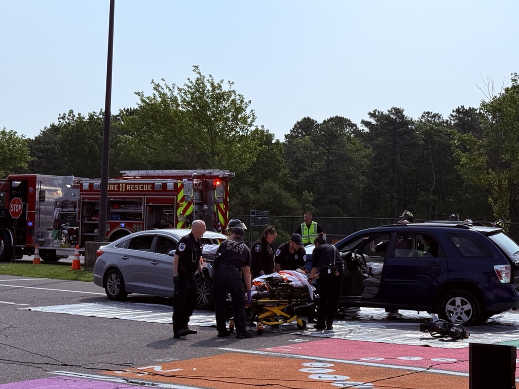Image of the EMS team placing extricated student on a stretcher. 