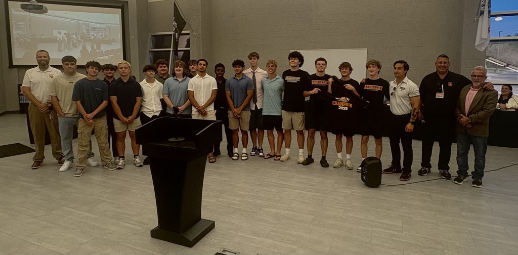 Boys lacrosse team posing with the Superintendent, Athletic Director, BOE President, and their coach.