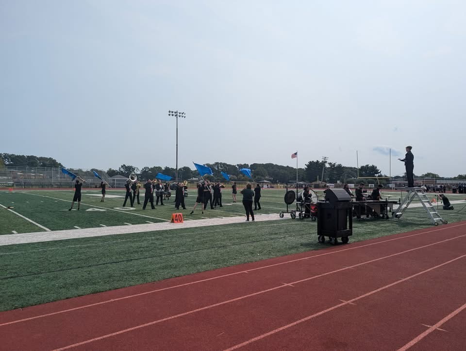 Image of the color guard performing to the music. 