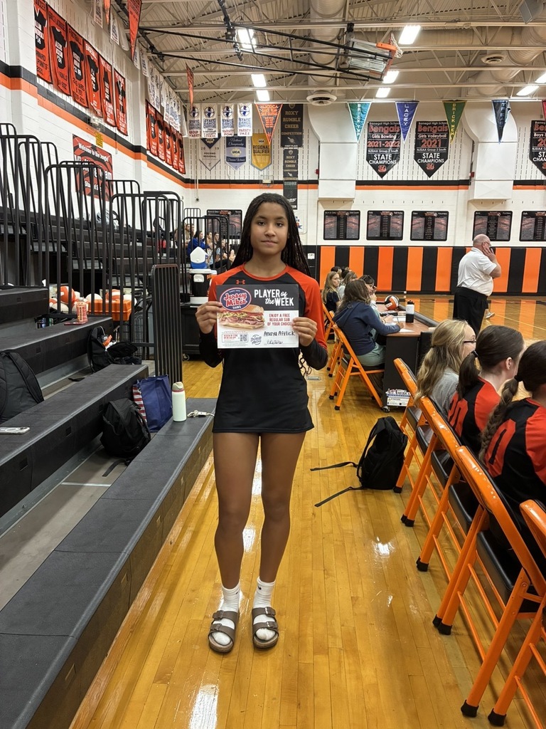 Amaya holding the certificate in the BHS gym. 