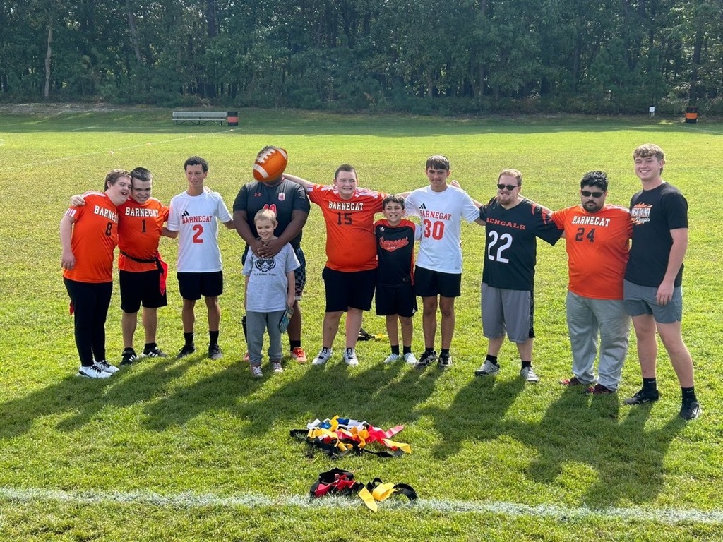 Image of the Challenger players and the support coaches posing on the field.