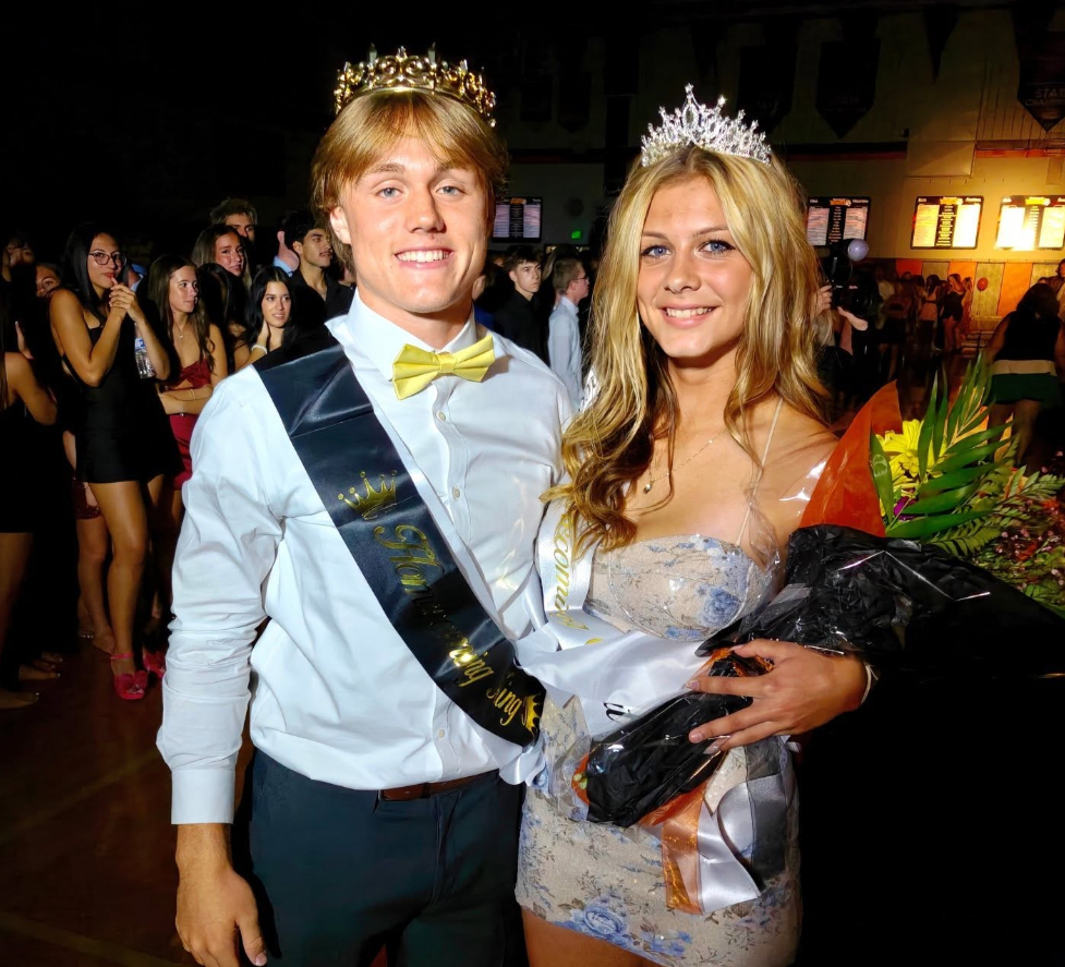 Image of Jack and Jadeyn holding flowers posing in their crowns. 