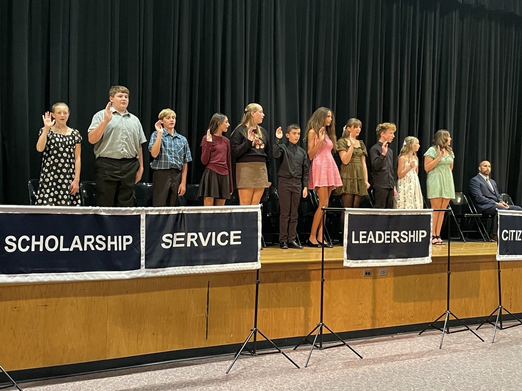 Image of the newest inductees standing on stage. 