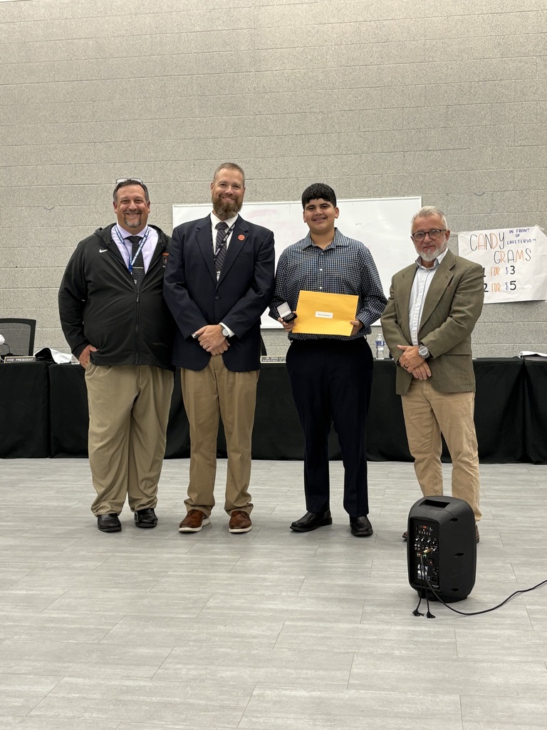 Image of Adam posing with the Principal, Superintendent, and BOE President.