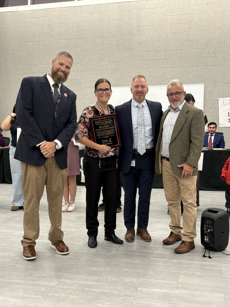 Image of Kirsten holding a plaque posing with the Superintendent, Director of Special Education, and BOE President