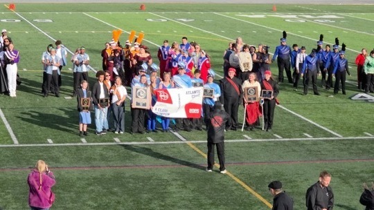 Image of the Marching Bengals posing for a picture on the field after being awarded 1st place. 