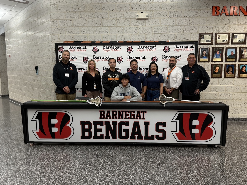 Image of Cedryk with his family, coach, building and district administrators. 